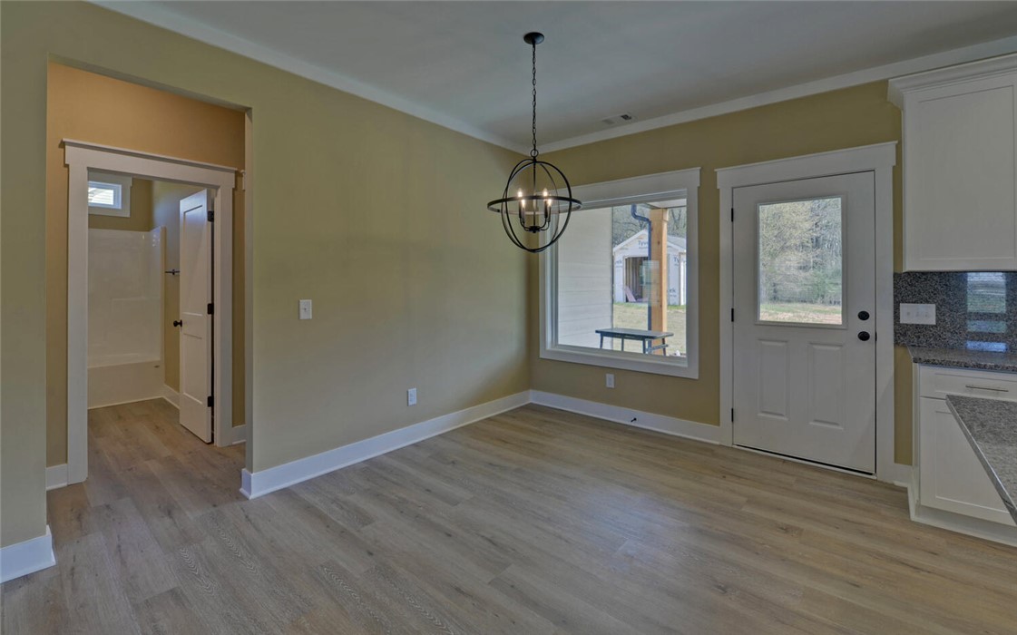 111 Topher Street Hartwell, GA 30643 - Photo 9 of 38 This bright space features sleek flooring and a contemporary light fixture.