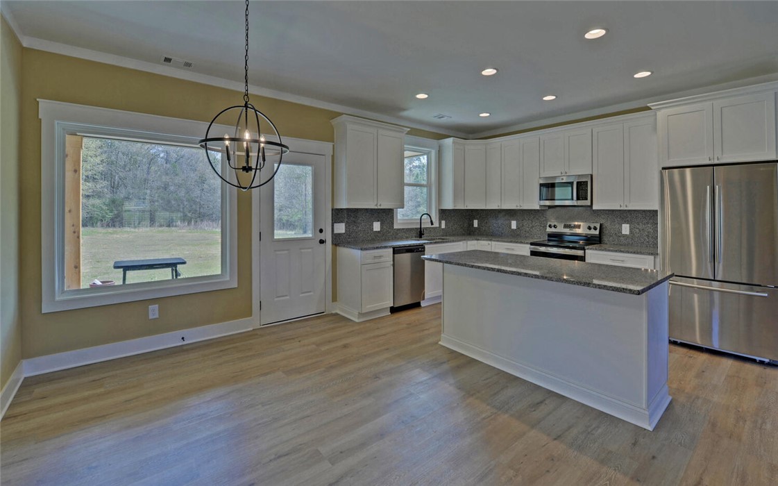111 Topher Street Hartwell, GA 30643 - Photo 10 of 38 This spacious kitchen offers a blend of style and functionality, perfect for everyday living.