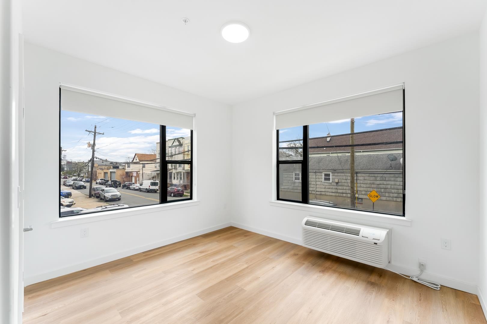 175 West 7th Street, Unit 502 Bayonne, NJ 07002 - Photo 12 of 33 an empty room with wooden floor and windows