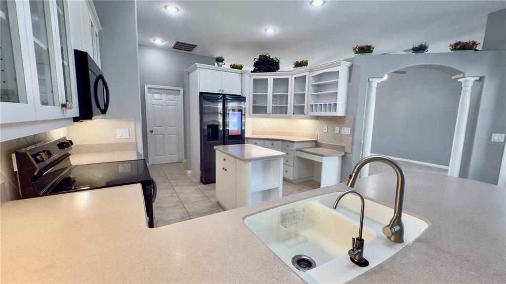 2049 Larissa Court Trinity, FL 34655 - Photo 12 of 61 a kitchen with stainless steel appliances granite countertop a sink and a refrigerator