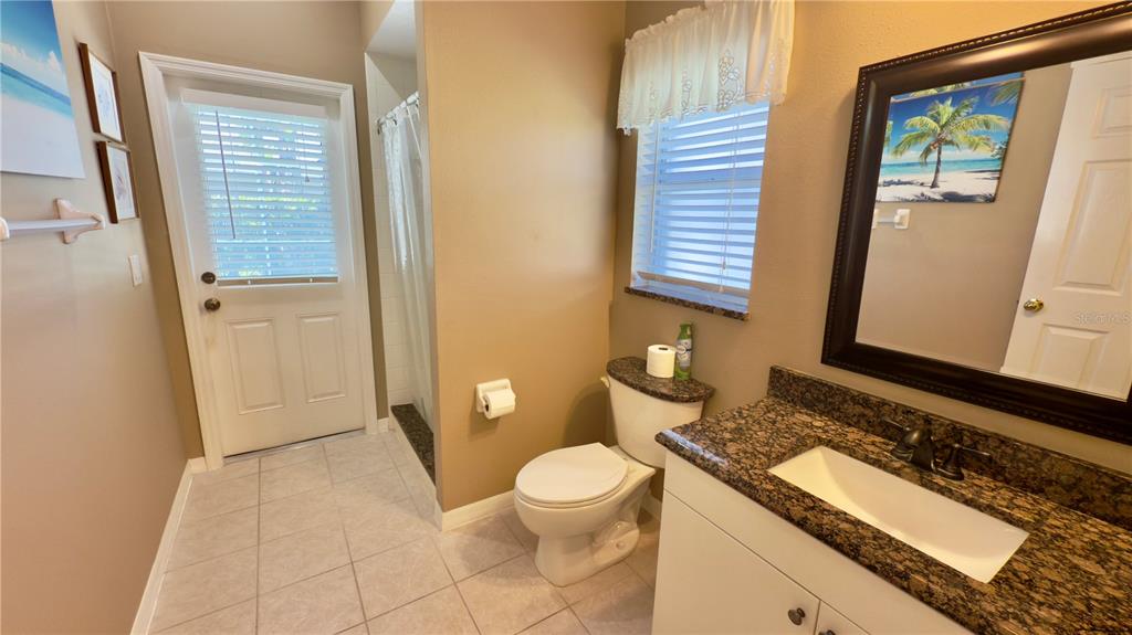 2049 Larissa Court Trinity, FL 34655 - Photo 21 of 61 a bathroom with a granite countertop sink and a mirror
