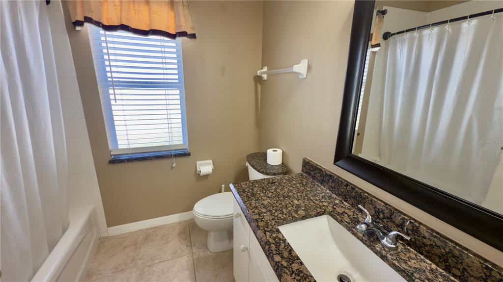 2049 Larissa Court Trinity, FL 34655 - Photo 26 of 61 a bathroom with a granite countertop sink and a mirror