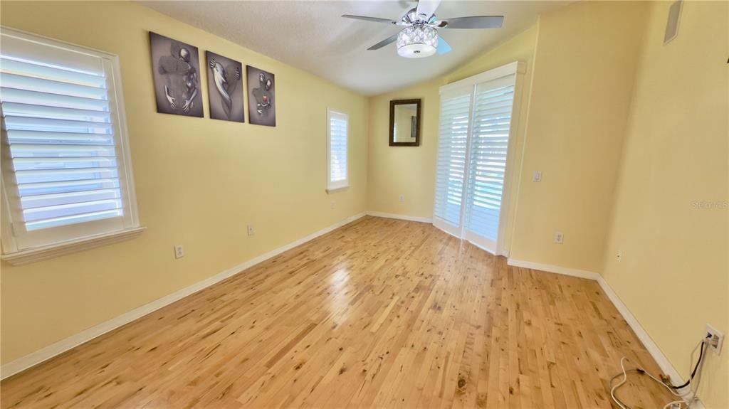 2049 Larissa Court Trinity, FL 34655 - Photo 32 of 61 a view of an empty room with wooden floor and a window