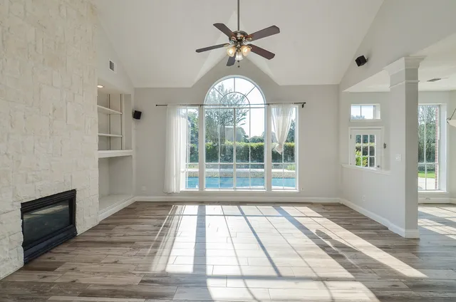a kitchen with stainless steel appliances granite countertop a stove a sink and a wooden floors