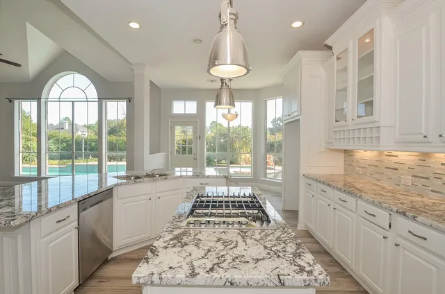 a front view of a house with a garden and tree