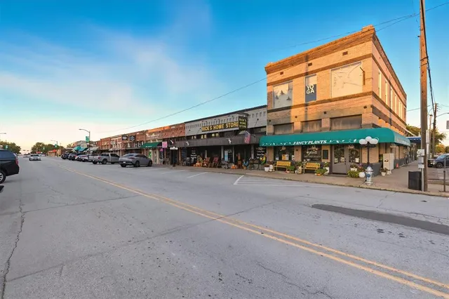 a couple of cars parked in front of a building