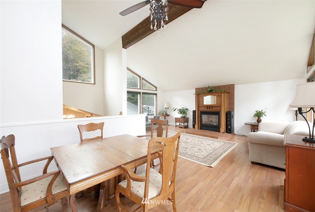 6793 Sills Road Clinton, WA 98236 - Photo 11 of 37 a living room with fireplace furniture and a table