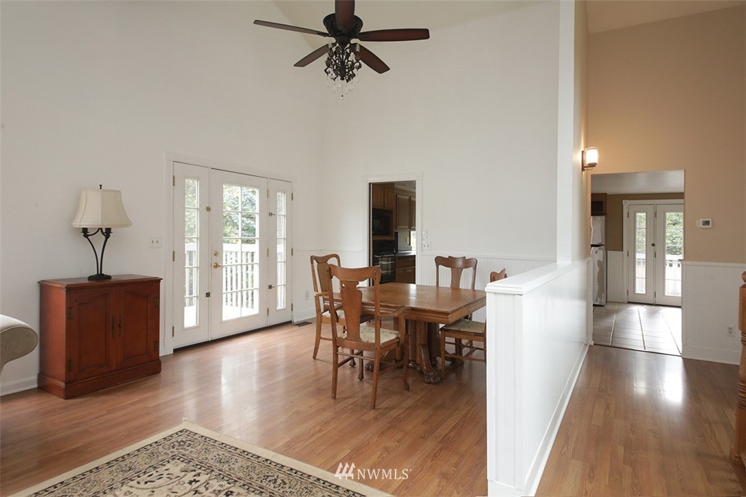 6793 Sills Road Clinton, WA 98236 - Photo 13 of 37 a view of a dining room with furniture window and wooden floor