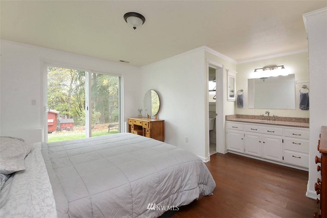 6793 Sills Road Clinton, WA 98236 - Photo 17 of 37 a bed room with a bed and a dresser