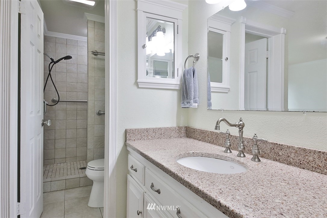 6793 Sills Road Clinton, WA 98236 - Photo 18 of 37 a bathroom with a granite countertop sink toilet and shower