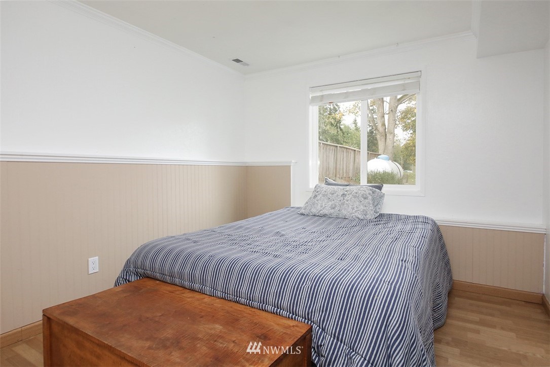 6793 Sills Road Clinton, WA 98236 - Photo 20 of 37 a bedroom with a bed and window