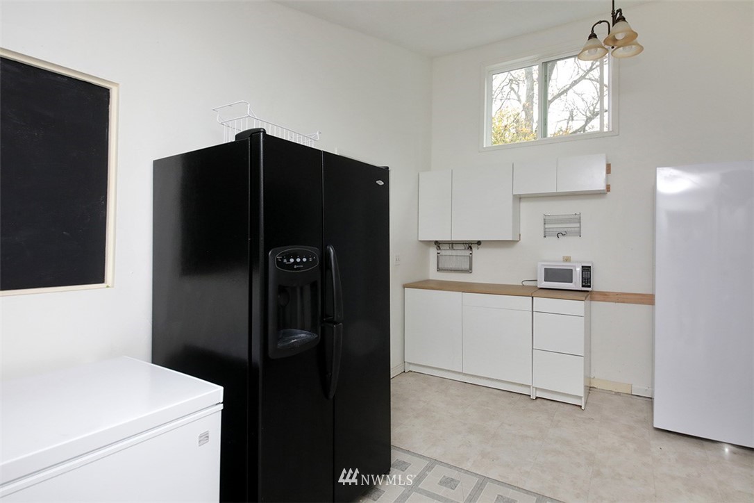 6793 Sills Road Clinton, WA 98236 - Photo 24 of 37 a kitchen with a refrigerator and a sink
