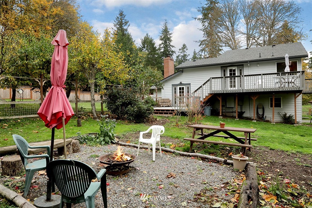 6793 Sills Road Clinton, WA 98236 - Photo 28 of 37 a view of a house with backyard and sitting area