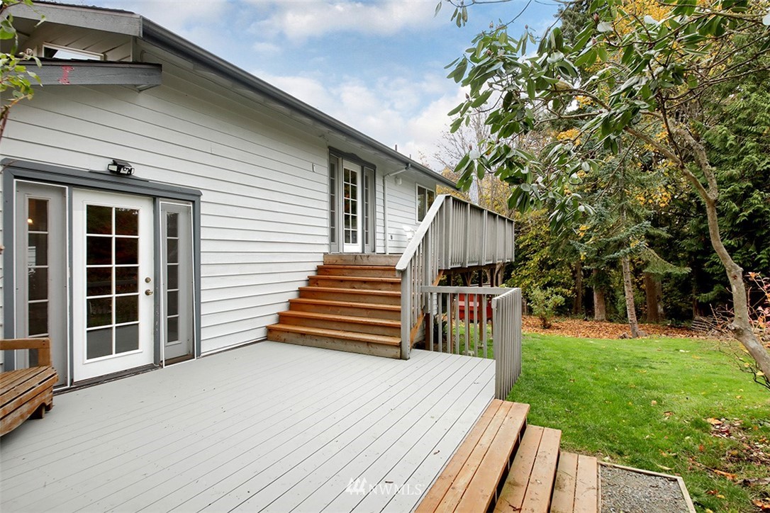 6793 Sills Road Clinton, WA 98236 - Photo 29 of 37 a view of a house with backyard and wooden deck