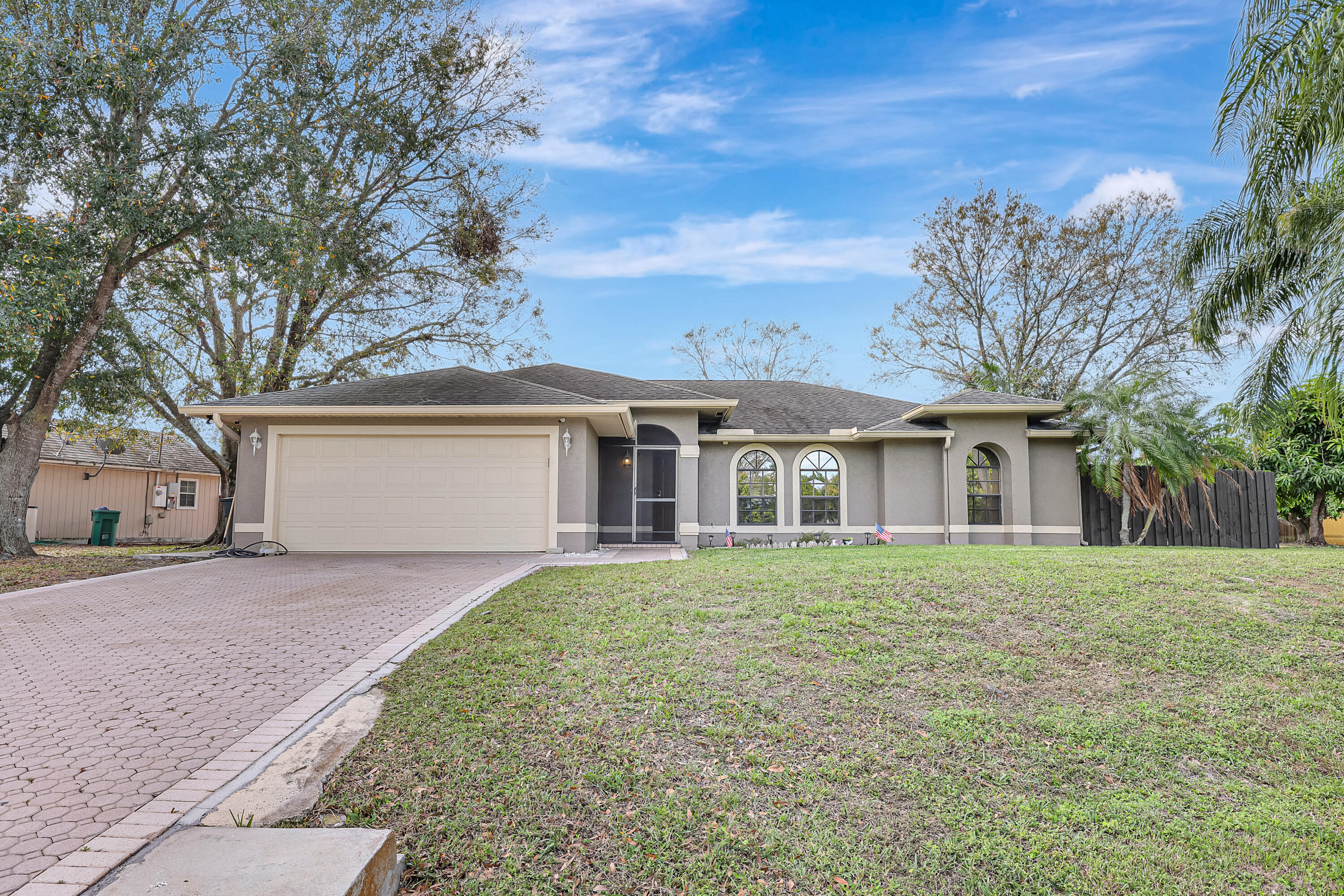 284 Southwest N Quick Circle Port St. Lucie, FL 34953 - Photo 1 of 18 front view of a house with a yard