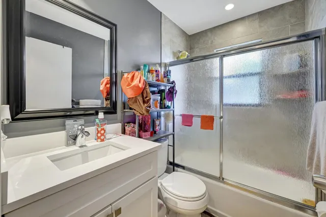 a bathroom with a sink toilet and shower