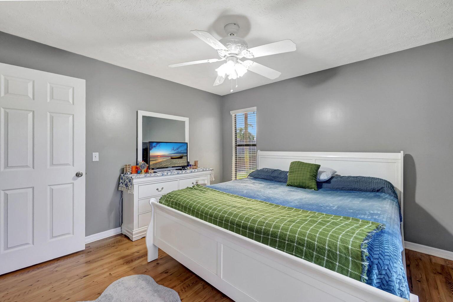 284 Southwest N Quick Circle Port St. Lucie, FL 34953 - Photo 12 of 18 a bedroom with a bed and a chandelier