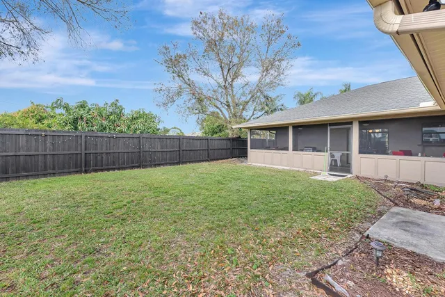 a view of a house with a backyard
