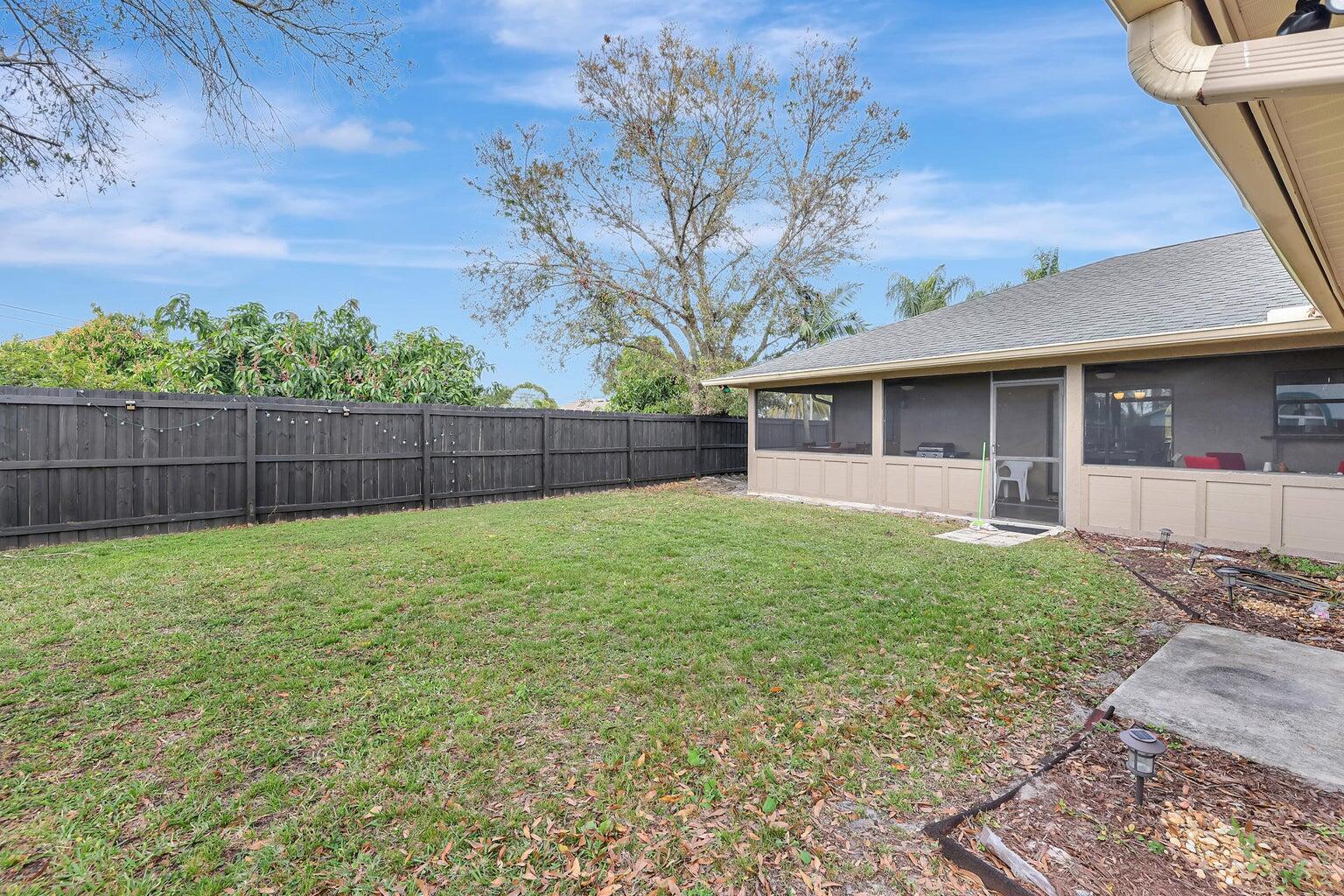 284 Southwest N Quick Circle Port St. Lucie, FL 34953 - Photo 17 of 18 a view of a house with a backyard