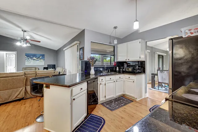 a kitchen with stainless steel appliances granite countertop a sink and cabinets
