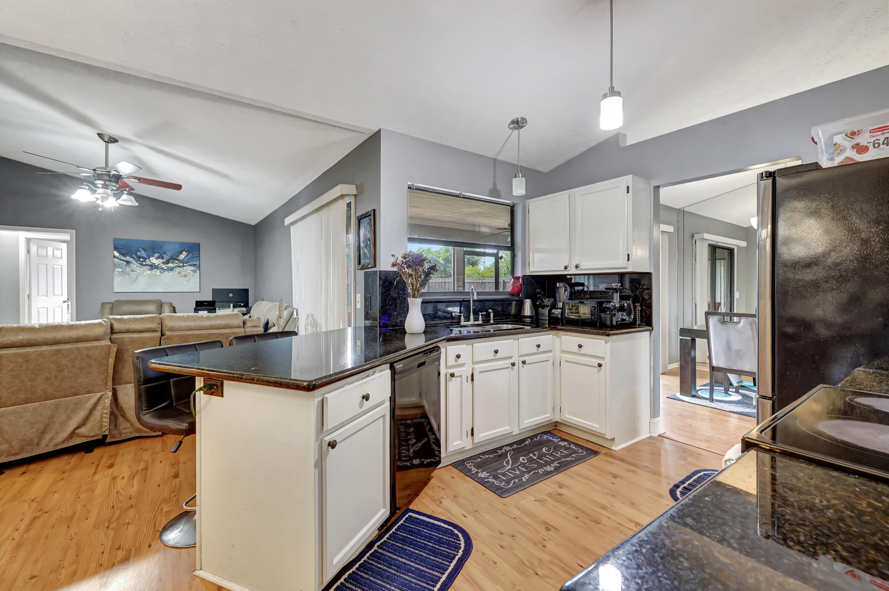 284 Southwest N Quick Circle Port St. Lucie, FL 34953 - Photo 2 of 18 a kitchen with stainless steel appliances granite countertop a sink and cabinets