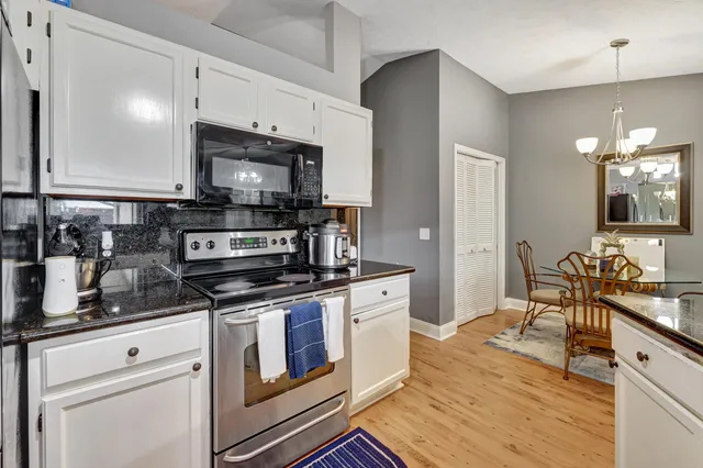 a kitchen with stainless steel appliances a stove microwave and sink