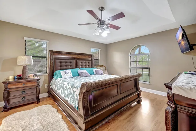 a bedroom with a bed and a chandelier