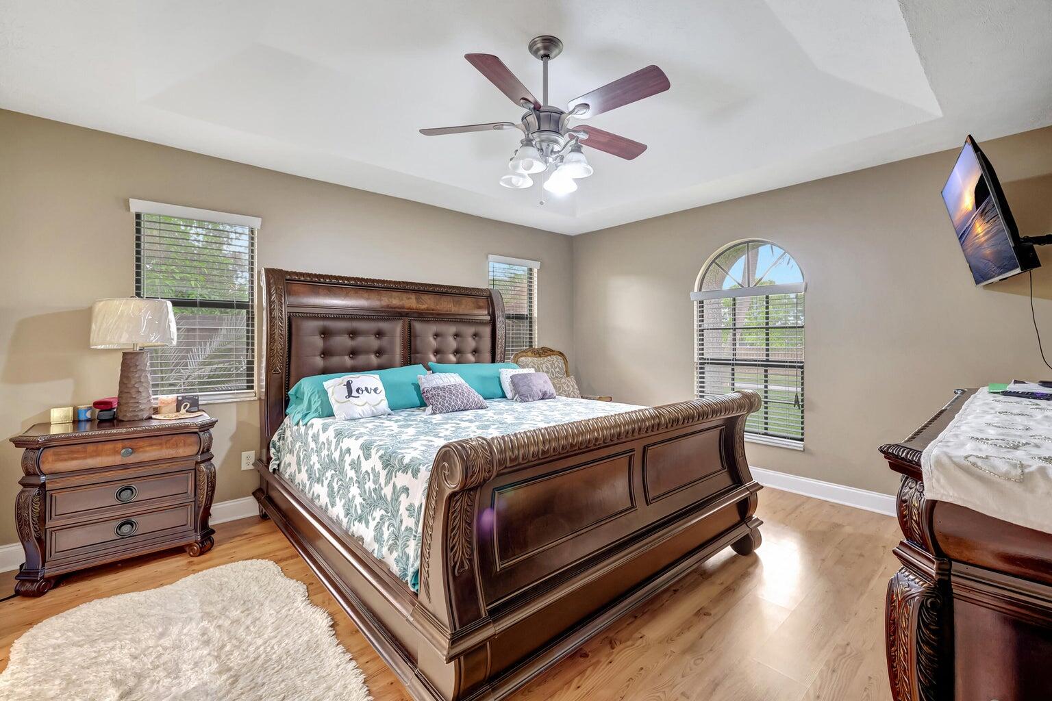 284 Southwest N Quick Circle Port St. Lucie, FL 34953 - Photo 8 of 18 a bedroom with a bed and a chandelier