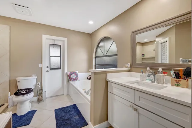 a bathroom with a sink mirror and toilet