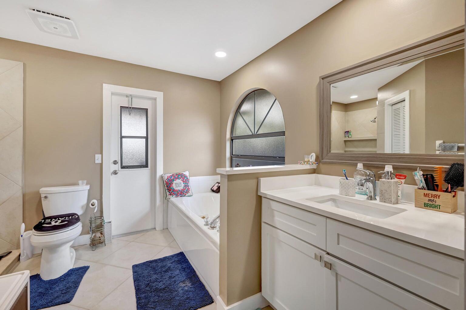 284 Southwest N Quick Circle Port St. Lucie, FL 34953 - Photo 9 of 18 a bathroom with a sink mirror and toilet