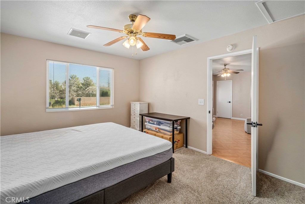 309 North Fairview Street Ridgecrest, CA 93555 - Photo 14 of 30 a bedroom with a bed and a chandelier