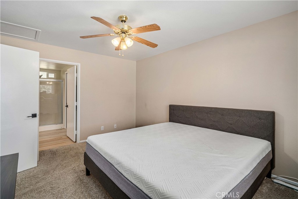 309 North Fairview Street Ridgecrest, CA 93555 - Photo 15 of 30 a bedroom with a bed and a chandelier