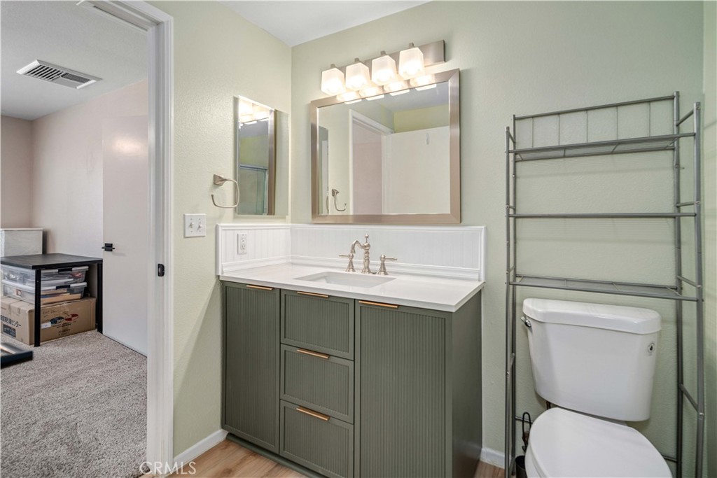 309 North Fairview Street Ridgecrest, CA 93555 - Photo 17 of 30 a bathroom with a toilet sink and mirror