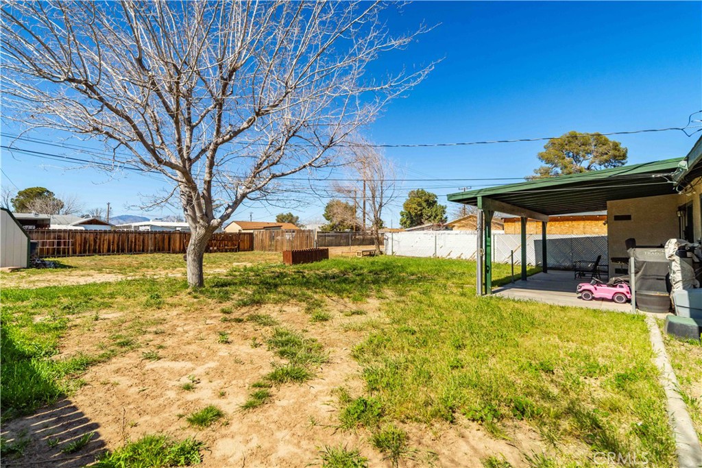 309 North Fairview Street Ridgecrest, CA 93555 - Photo 25 of 30 a view of a backyard with table and chairs and potted plants