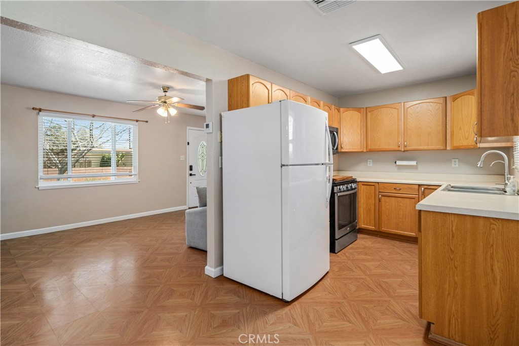 309 North Fairview Street Ridgecrest, CA 93555 - Photo 10 of 30 a kitchen with a refrigerator a stove top oven a sink and dishwasher
