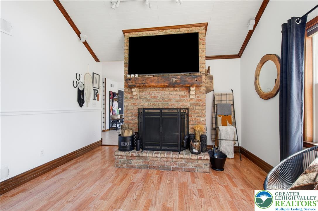 890 Lahr Road Nazareth, PA 18064 - Photo 20 of 71 A striking brick fireplace forms a cozy focal point in this inviting living space.