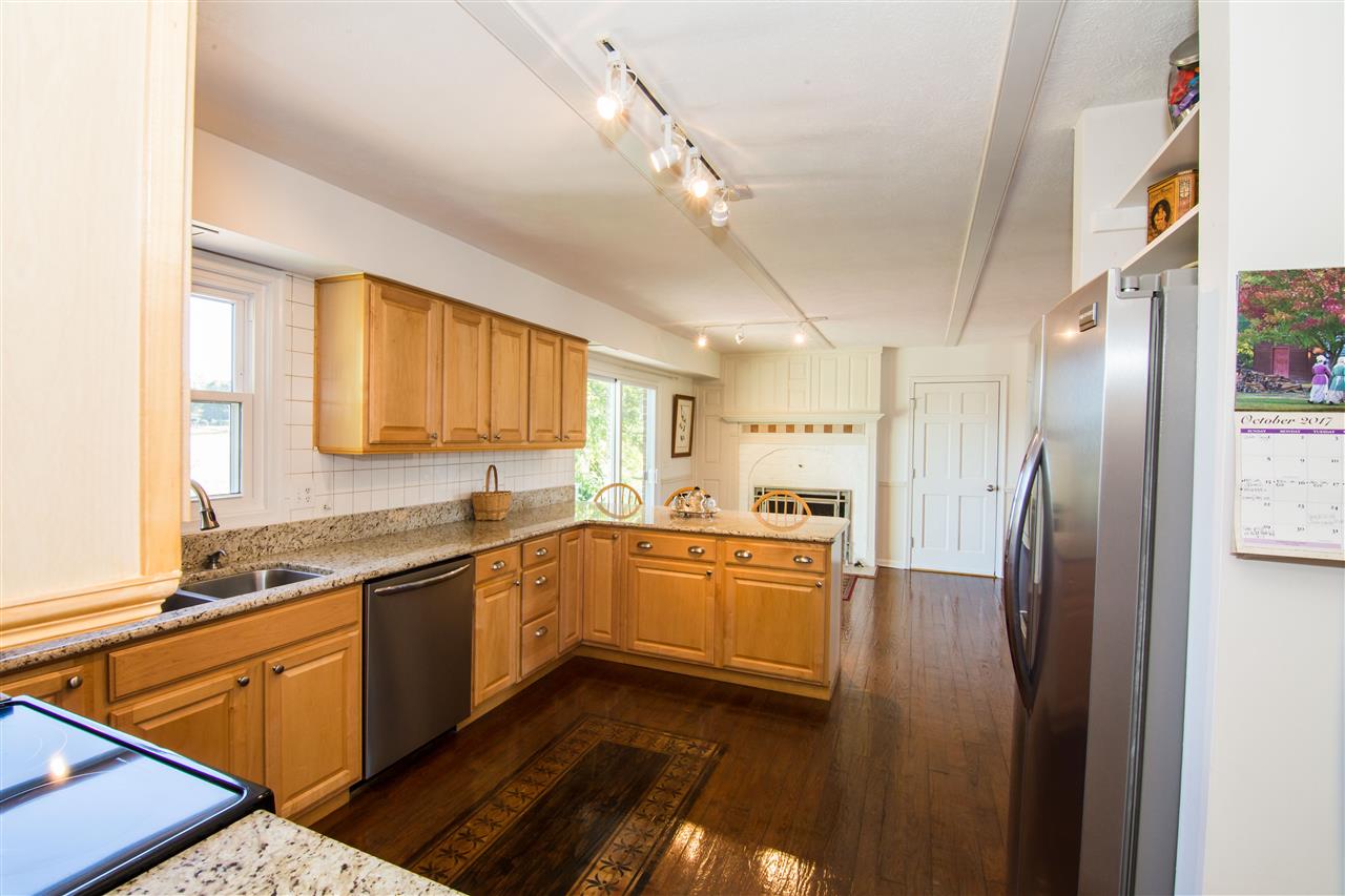 9139 Centerville Road Bridgewater, VA 22812 - Photo 20 of 50 a kitchen with stainless steel appliances granite countertop a refrigerator a sink dishwasher a stove and white countertops with wooden floor