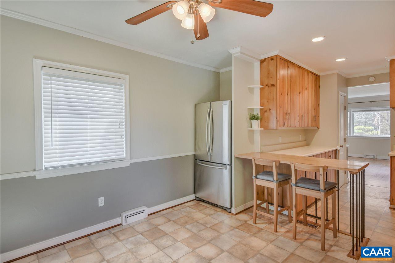 442 Rio Road West Charlottesville, VA 22901 - Photo 22 of 48 a kitchen with stainless steel appliances kitchen island granite countertop a refrigerator a stove a microwave oven with white cabinets and island