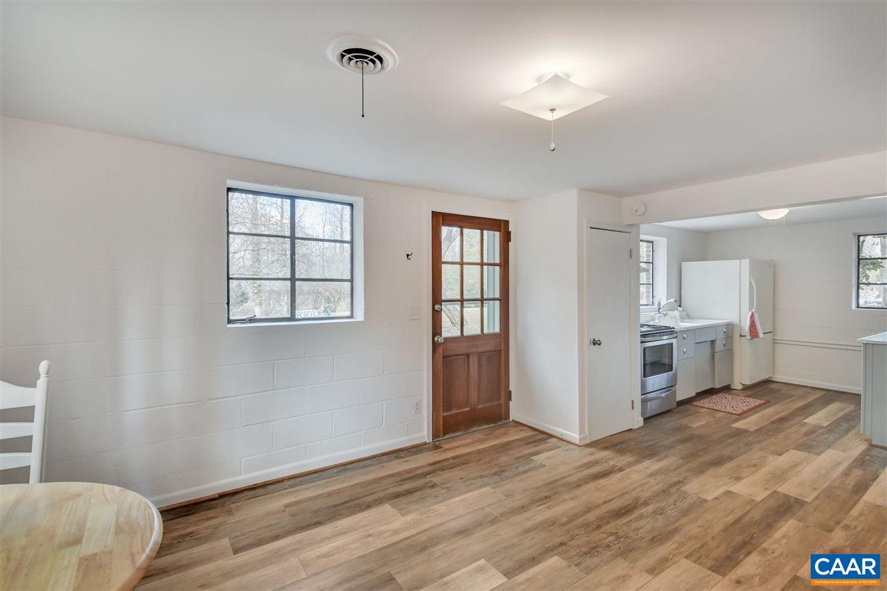 442 Rio Road West Charlottesville, VA 22901 - Photo 39 of 48 a view of an empty room with a window and wooden floor
