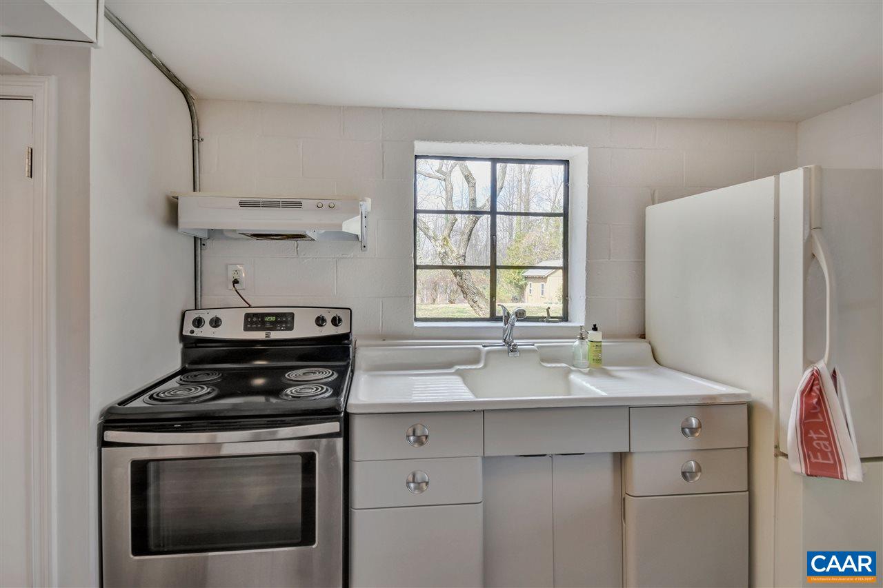 442 Rio Road West Charlottesville, VA 22901 - Photo 42 of 48 a kitchen with stainless steel appliances granite countertop a sink stove and refrigerator