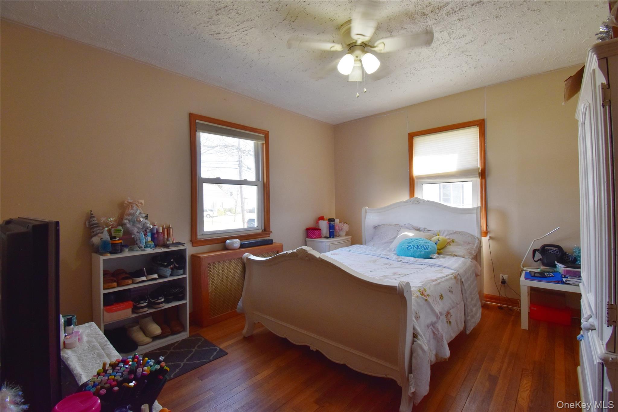6 Sullivan Road Farmingdale, NY 11735 - Photo 16 of 21 a bedroom with a bed and wooden floor