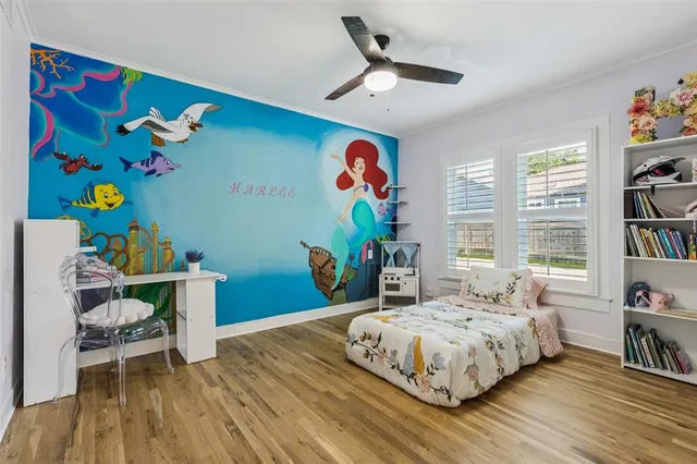 a bedroom with a bed table and a window