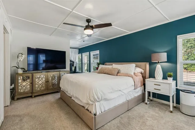 a bed room with a bed and a flat screen tv