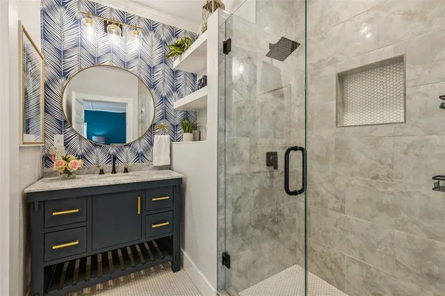 a bathroom with a sink a mirror and a shower