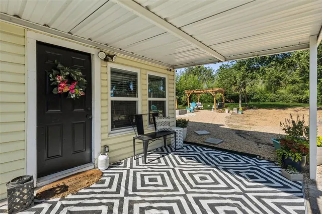 a view of a patio with table and chairs and potted plants
