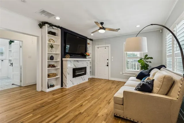 a living room with furniture a flat screen tv and a fireplace