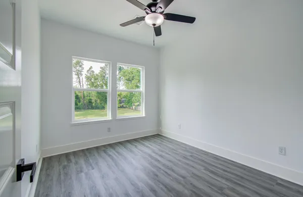 wooden floor in an empty room with a window