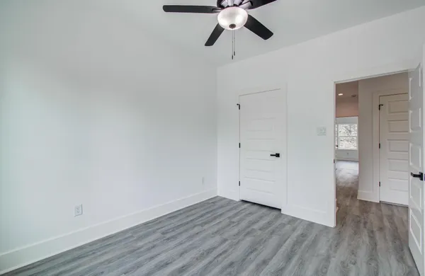 a view of an empty room and wooden floor