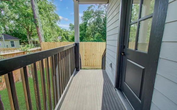 a balcony view with hardwood floor