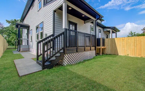 a view of a house with a yard and deck